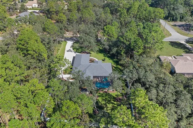 a view of yard with swimming pool and green space