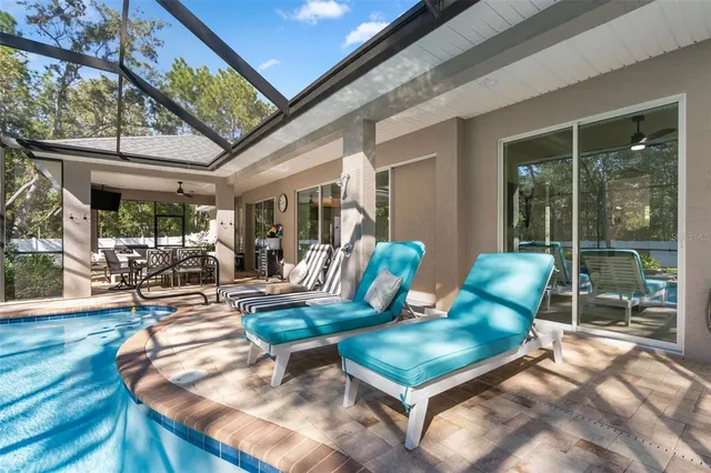 a large bedroom with a large bed and a large window with the outer view