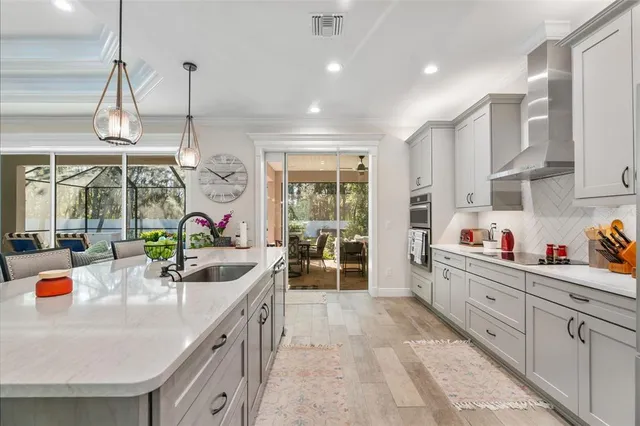 a kitchen with stainless steel appliances granite countertop a sink and a large window
