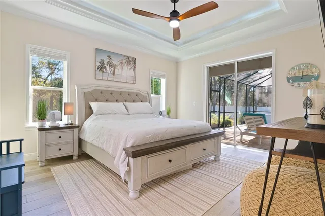 a bedroom with bed and a painting on the wall