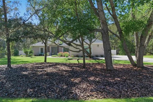 a view of a house with a backyard