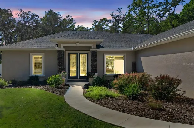 a front view of house with yard and green space