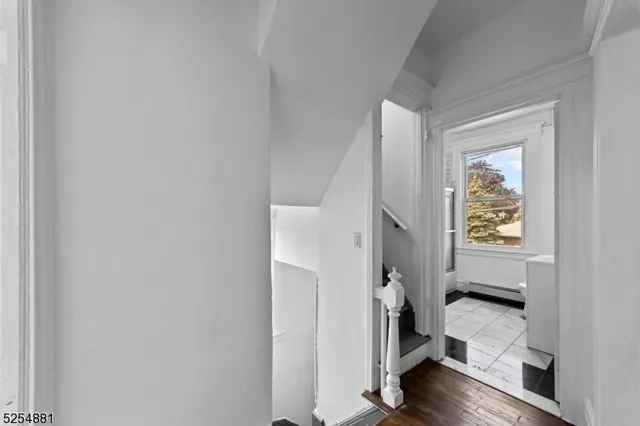 a view of an entryway with wooden floor