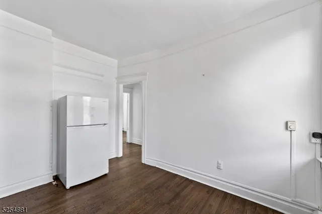 an empty room with wooden floor