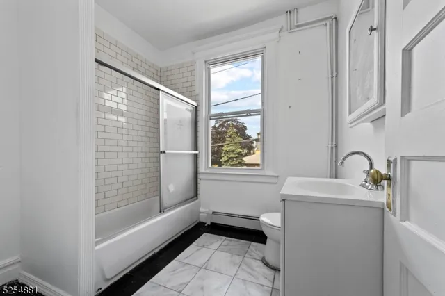 a bathroom with a sink a bathtub and a shower