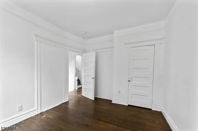 an empty room with wooden floor