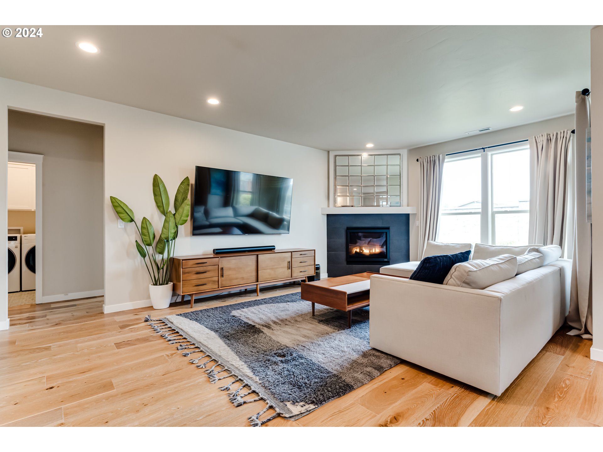 3744 Siletz Drive Eugene, OR 97408 - Photo 11 of 31 a living room with furniture flat screen tv and a fireplace
