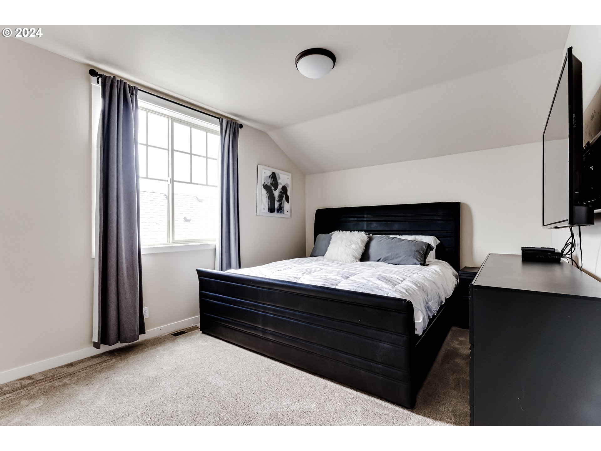 3744 Siletz Drive Eugene, OR 97408 - Photo 23 of 31 a bedroom with a bed and a flat tv screen on dresser