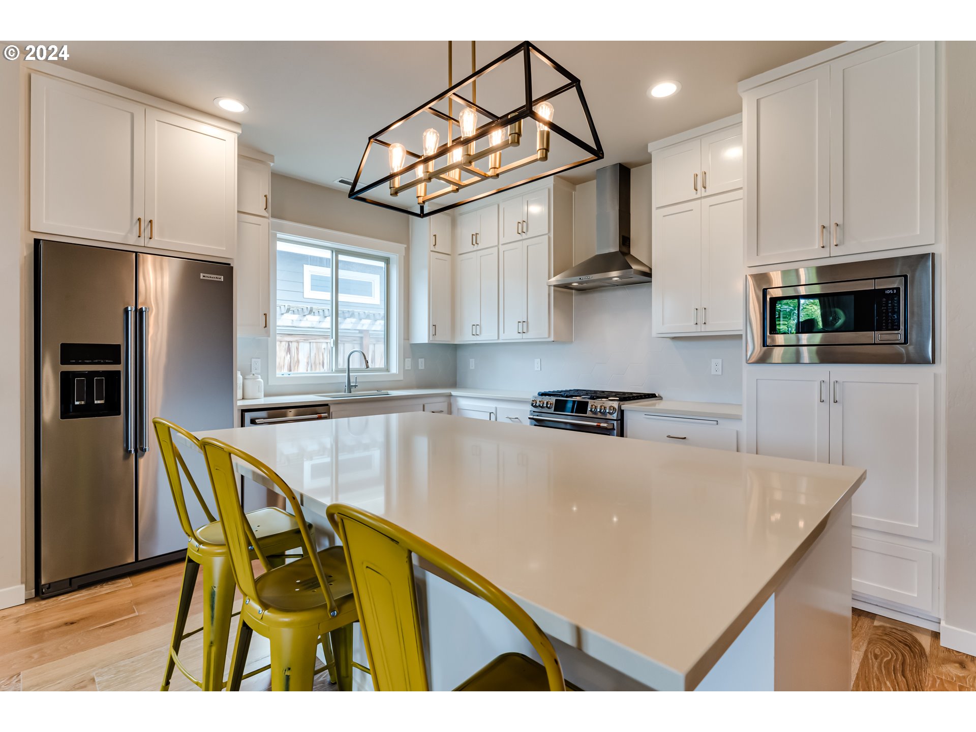 3744 Siletz Drive Eugene, OR 97408 - Photo 7 of 31 a kitchen with stainless steel appliances granite countertop a sink a stove a refrigerator cabinets and a dining table