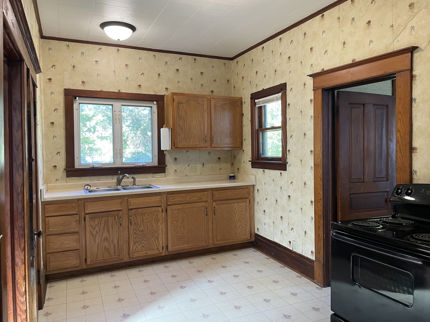 907 East Madison Street Pontiac, IL 61764 - Photo 12 of 21 a kitchen with sink a stove and a window