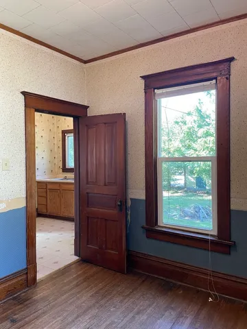 a view of a livingroom with a bedroom and a window