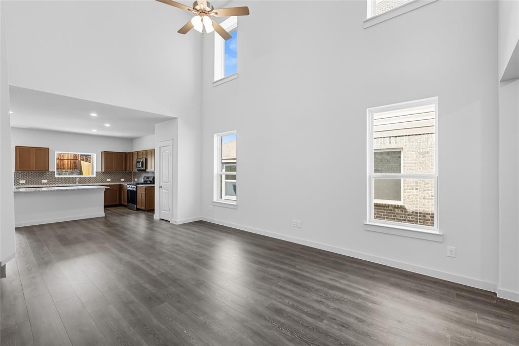 519 Martell Road Lowry Crossing, TX 75407 - Photo 11 of 35 a view of an empty room with a window and wooden floor
