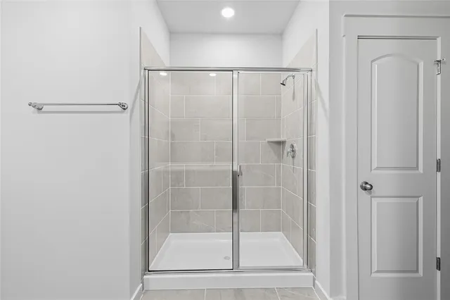 a bathroom with a glass shower door