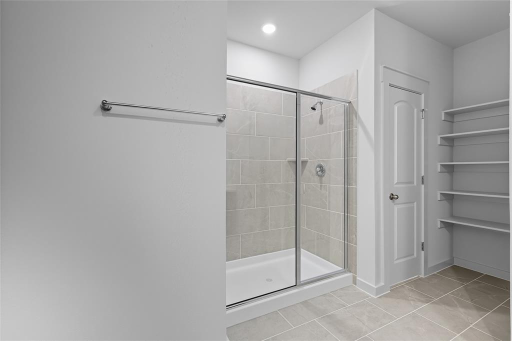 519 Martell Road Lowry Crossing, TX 75407 - Photo 17 of 35 a bathroom with a shower and a glass door