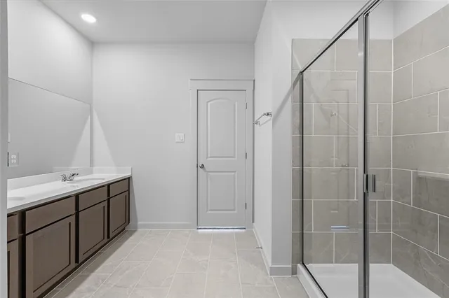 a bathroom with a shower and a sink