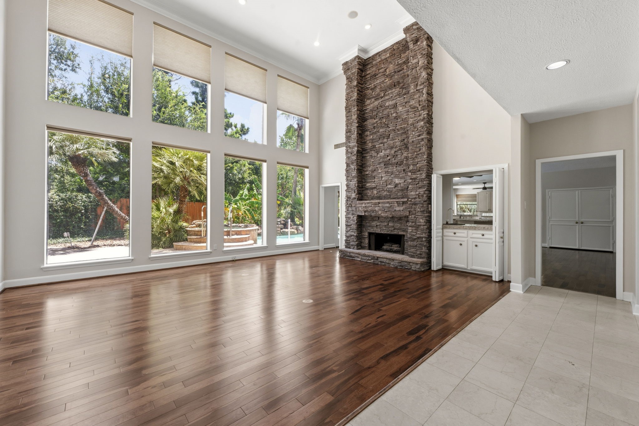 18503 Cabaniss Circle Spring, TX 77379 - Photo 11 of 49 A dramatic two-story wall of windows fills the formal living room with natural light while showcasing views of the backyard oasis.