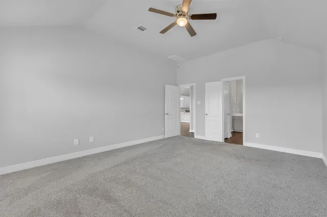 a view of a room with a ceiling fan