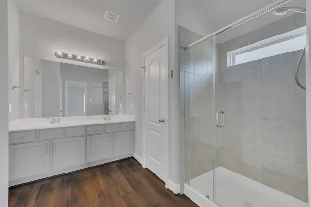 a bathroom with a tub shower and sink