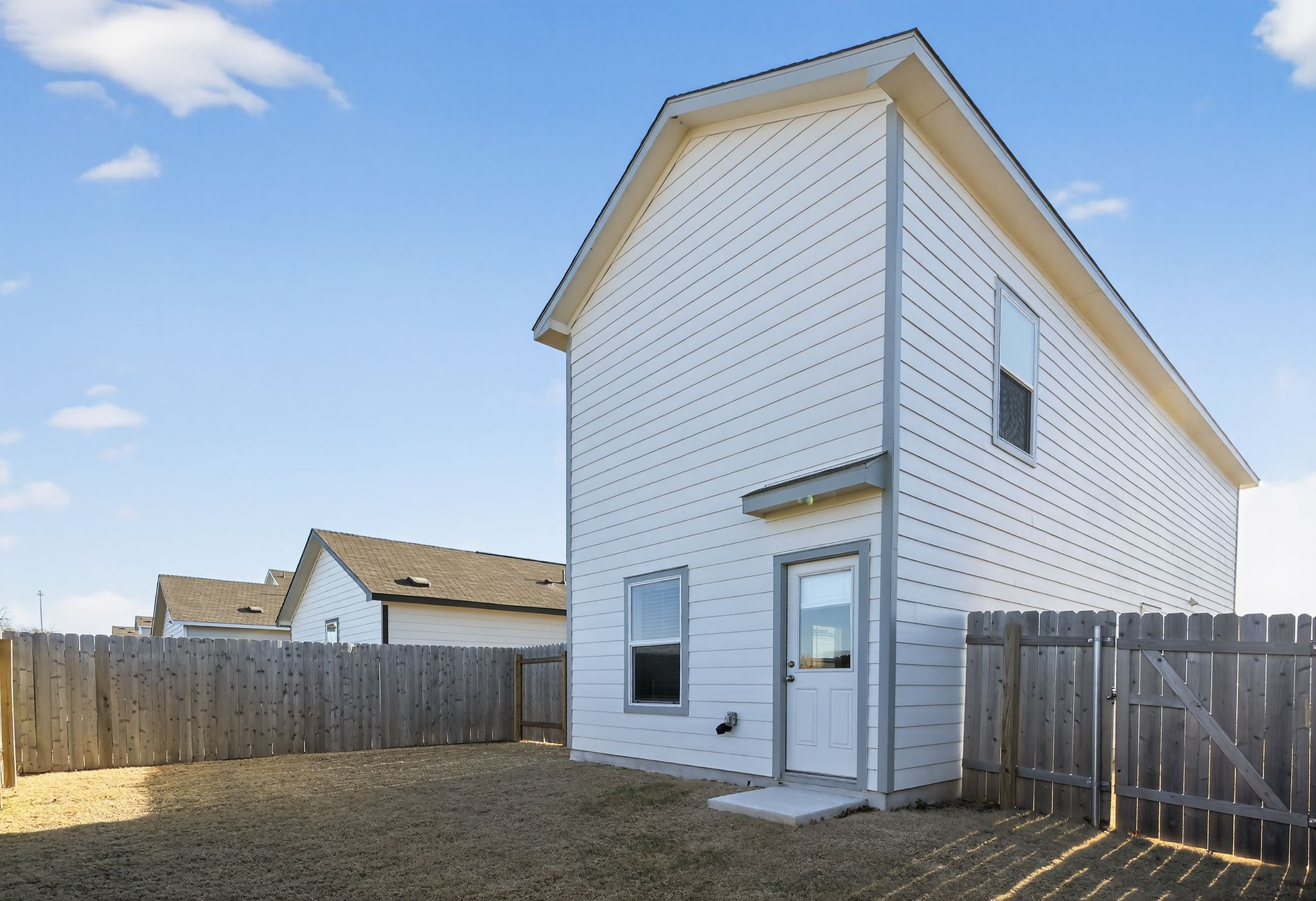 612 Marty Allen Loop Jarrell, TX 76537 - Photo 14 of 15 Rear view of property featuring a fenced backyard and a gate