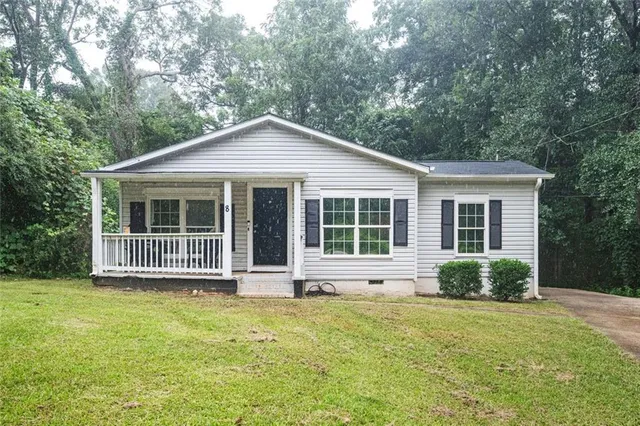 a front view of a house with a garden