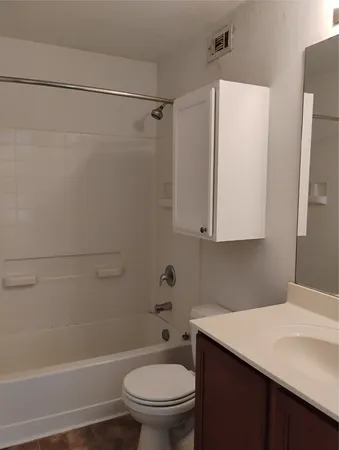 a small space with a window and a chandelier fan