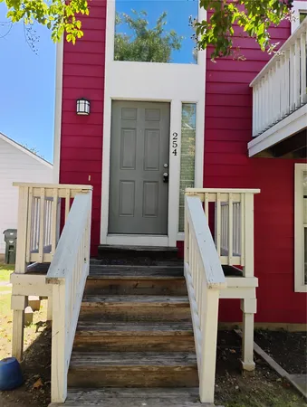 a front view of a house with wooden stairs