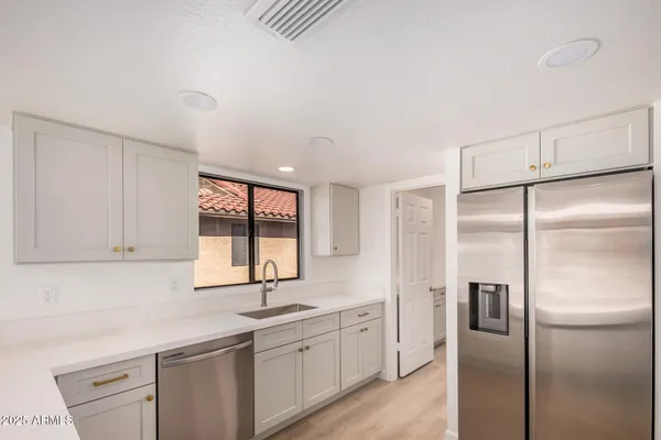 a kitchen with a refrigerator and a sink