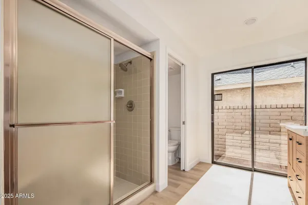 a bathroom with a shower and a glass door