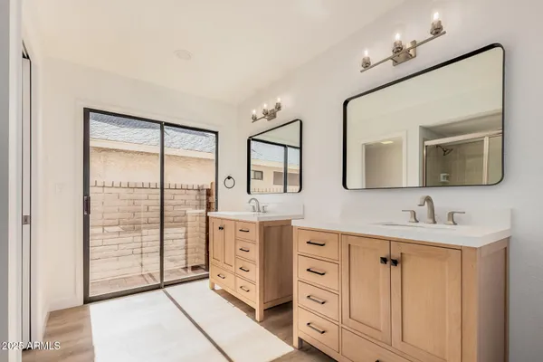 a bathroom with a double vanity sink and mirror