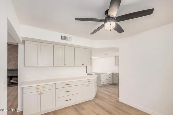 a kitchen with a refrigerator a sink and cabinets