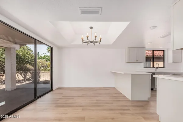 a kitchen with kitchen island a counter top space wooden floor and stainless steel appliances