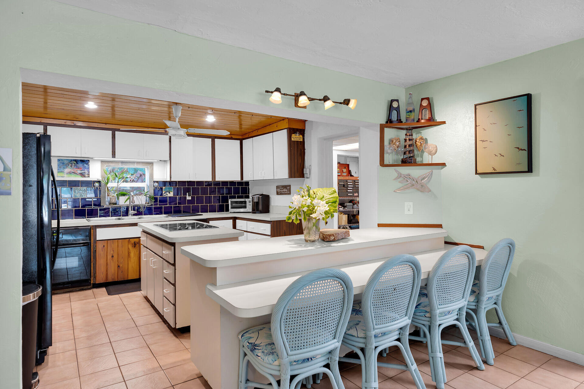 16 Janet Place Key Largo, FL 33037 - Photo 11 of 29 a kitchen with stainless steel appliances granite countertop a stove top oven a sink a dining table and chairs