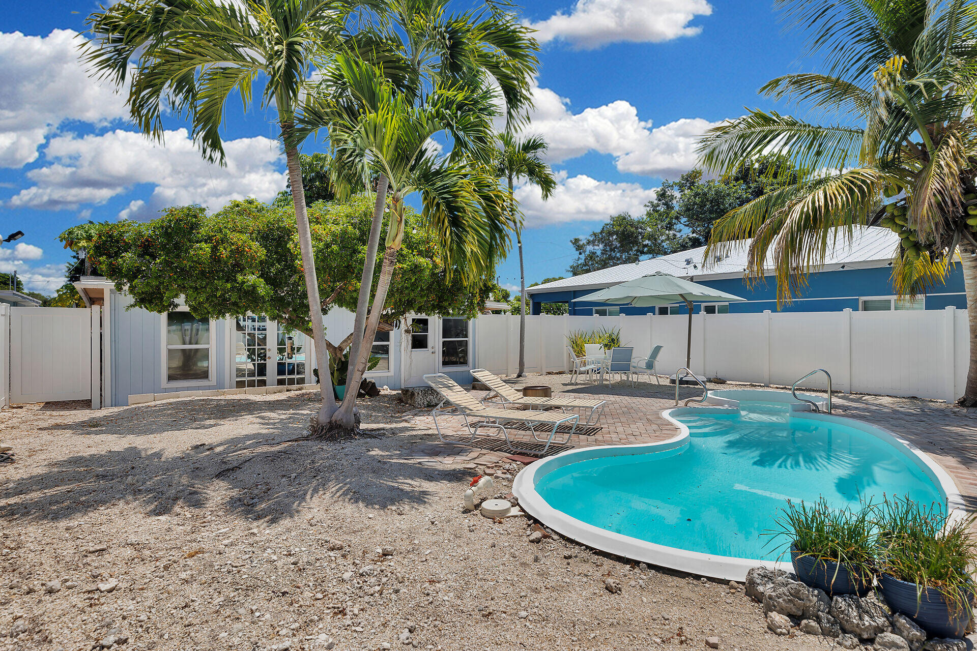 16 Janet Place Key Largo, FL 33037 - Photo 5 of 29 front view of a house with swimming pool and porch
