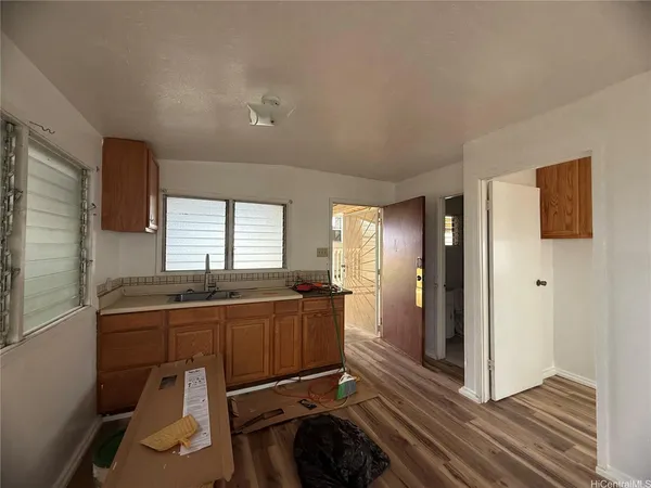 a kitchen with granite countertop a sink and wooden cabinets