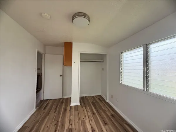 a view of a room with wooden floor and window