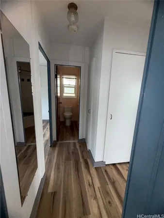 a view of a hallway view with wooden floor and staircase