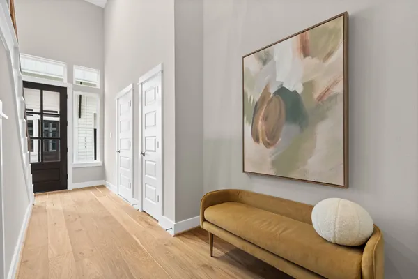 a bedroom with a bed a table and a large mirror