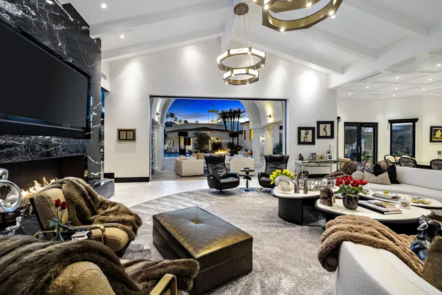 a view of a patio with dining table and chairs with a barbeque grill and a fireplace