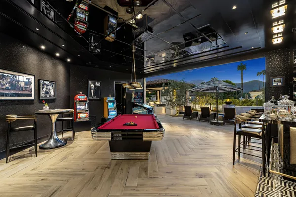 a bedroom with a bed couches and a flat screen tv