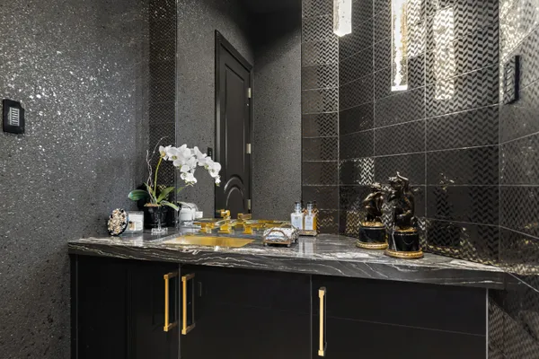 a bathroom with a granite countertop sink a toilet and shower