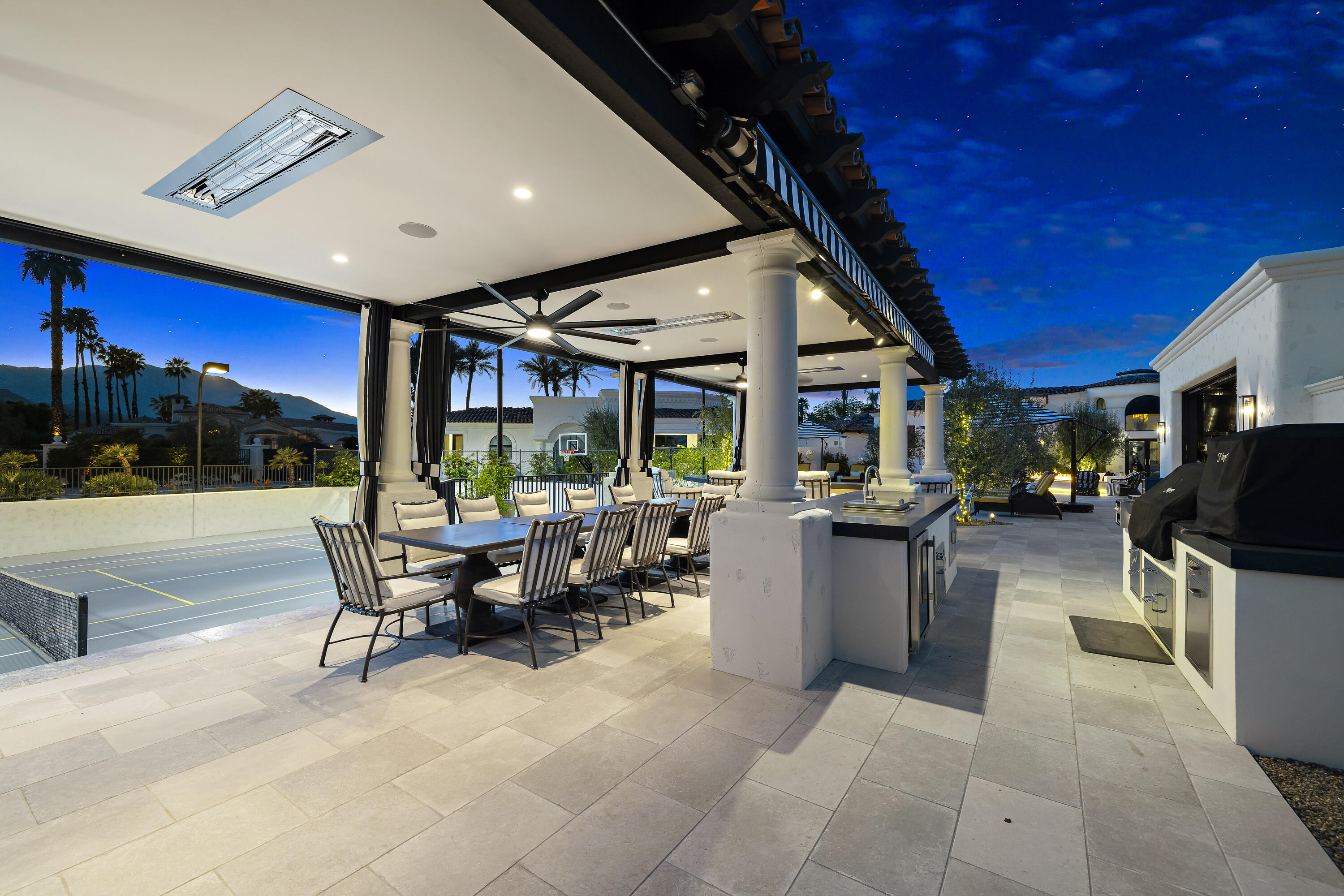 40440 Morningstar Road Rancho Mirage, CA 92270 - Photo 18 of 64 a view of a patio with dining table and chairs with a barbeque grill and a fireplace