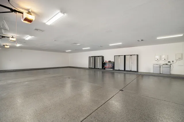 a bedroom with a bed couches and a flat screen tv