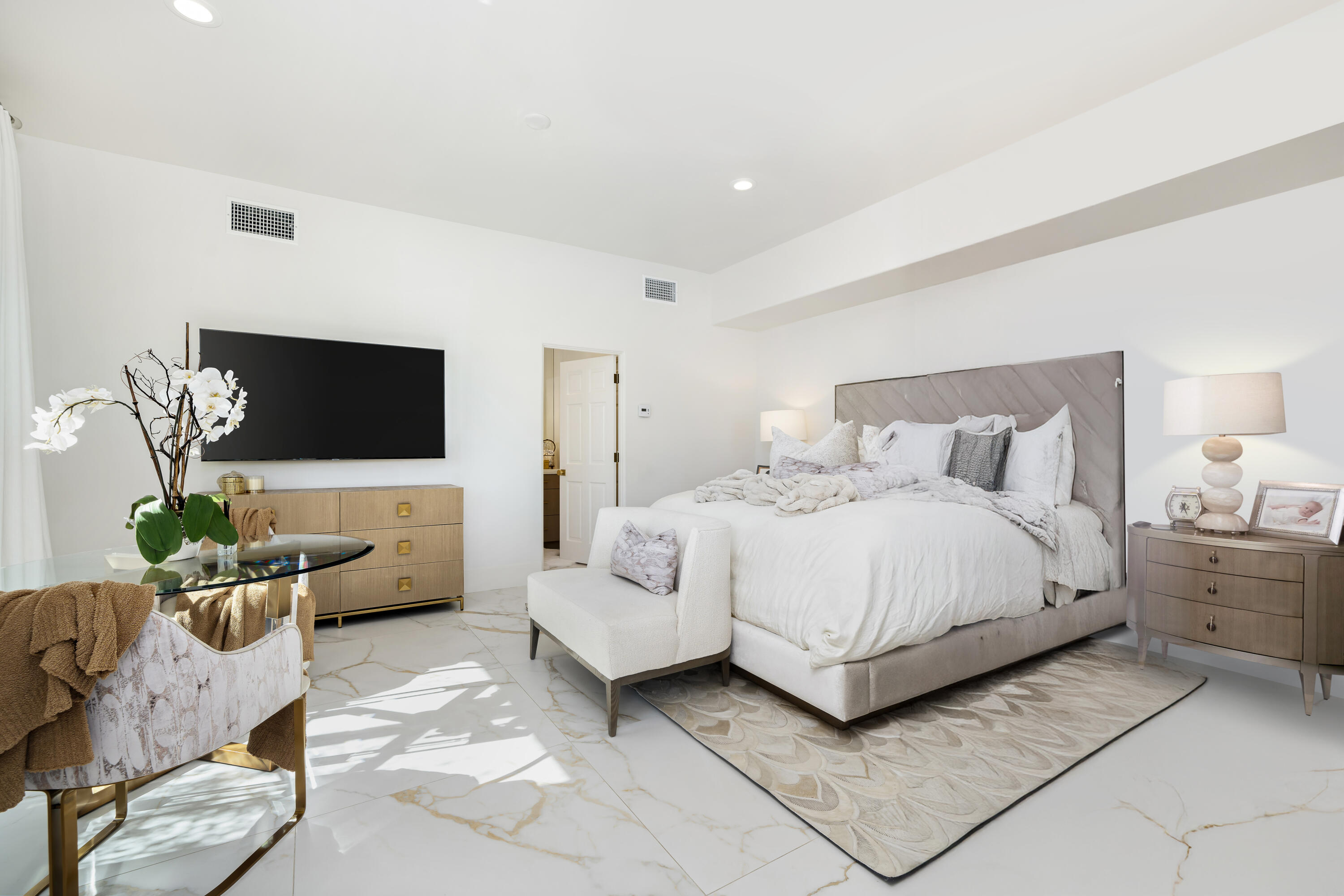 40440 Morningstar Road Rancho Mirage, CA 92270 - Photo 31 of 64 a bedroom with a bed couches and a flat screen tv