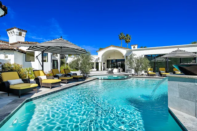 a living room with furniture and floor to ceiling windows