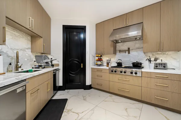 a view of a patio with dining table and chairs with a barbeque grill and a fireplace