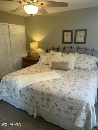 a large bed sitting in a bedroom and lamp