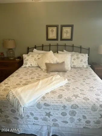 a bedroom with a bed and a night stand