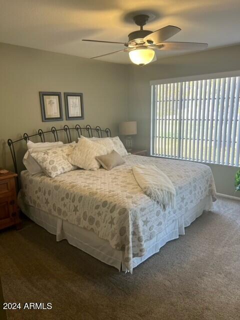8700 East Mountain View Road, Unit 1058 Scottsdale, AZ 85258 - Photo 16 of 31 a bedroom with a bed and a chandelier