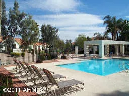 a view of a house with swimming pool and sitting area
