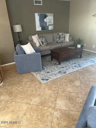 a living room with furniture and a rug